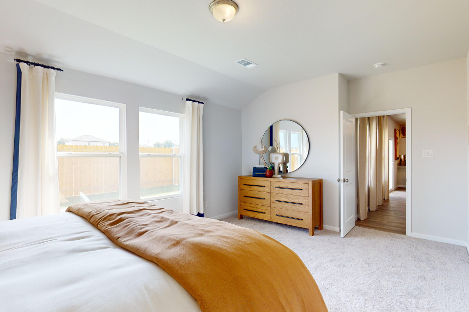 A bedroom with a large window.