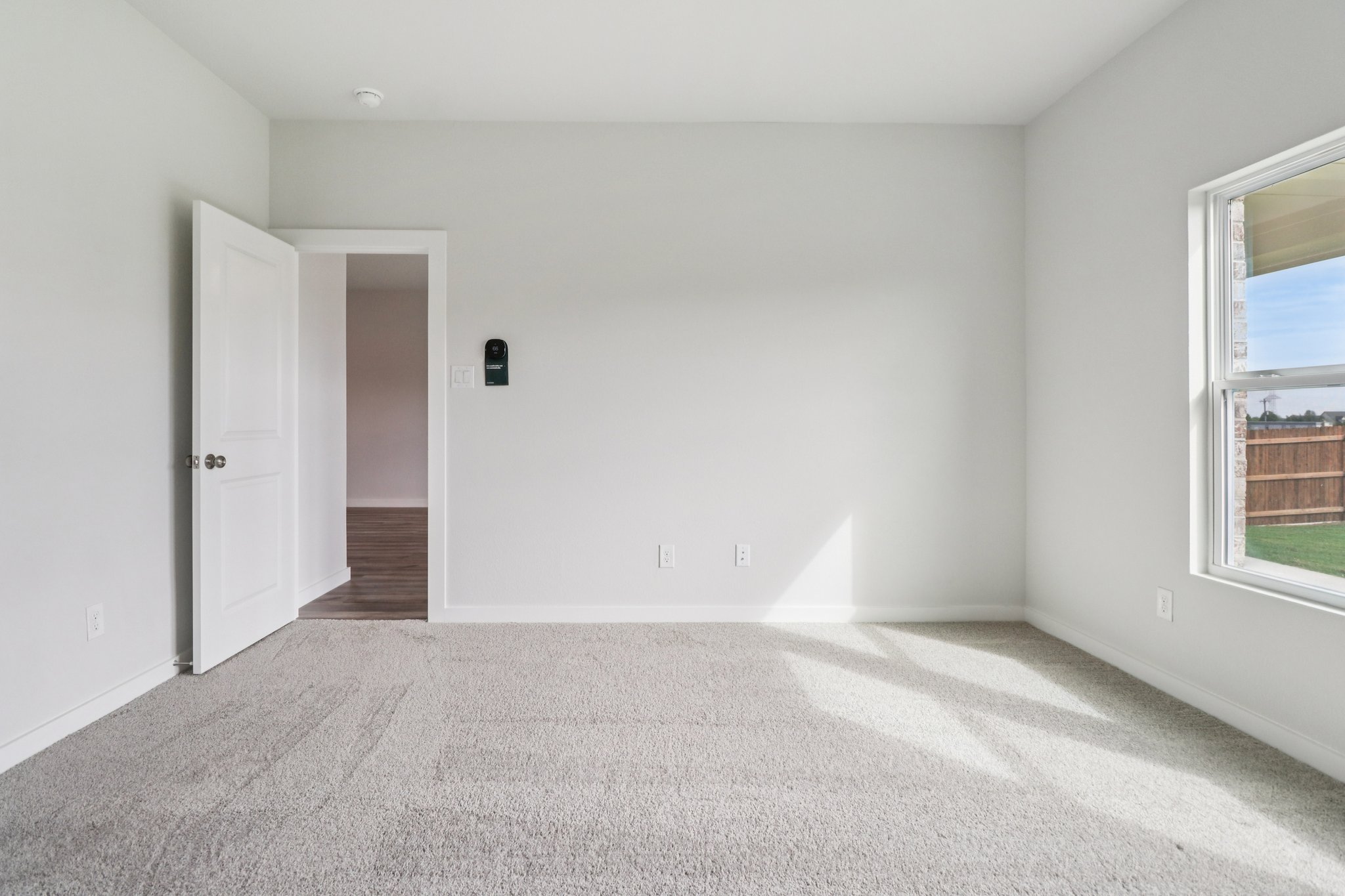 A hallway with white walls.