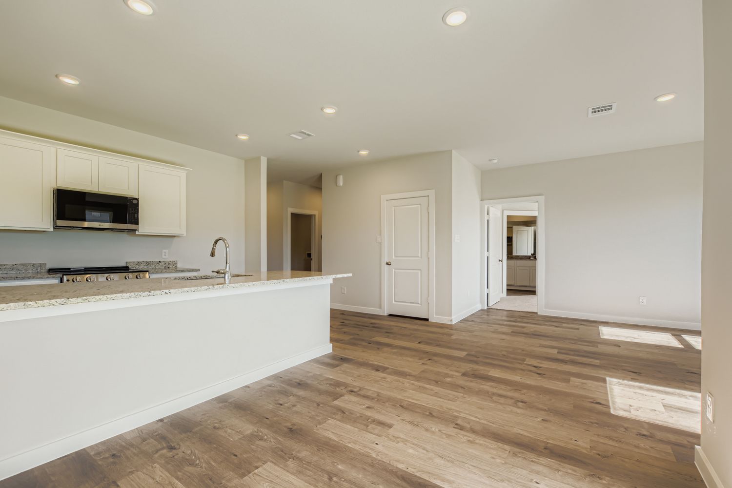 A kitchen with white cabinets.