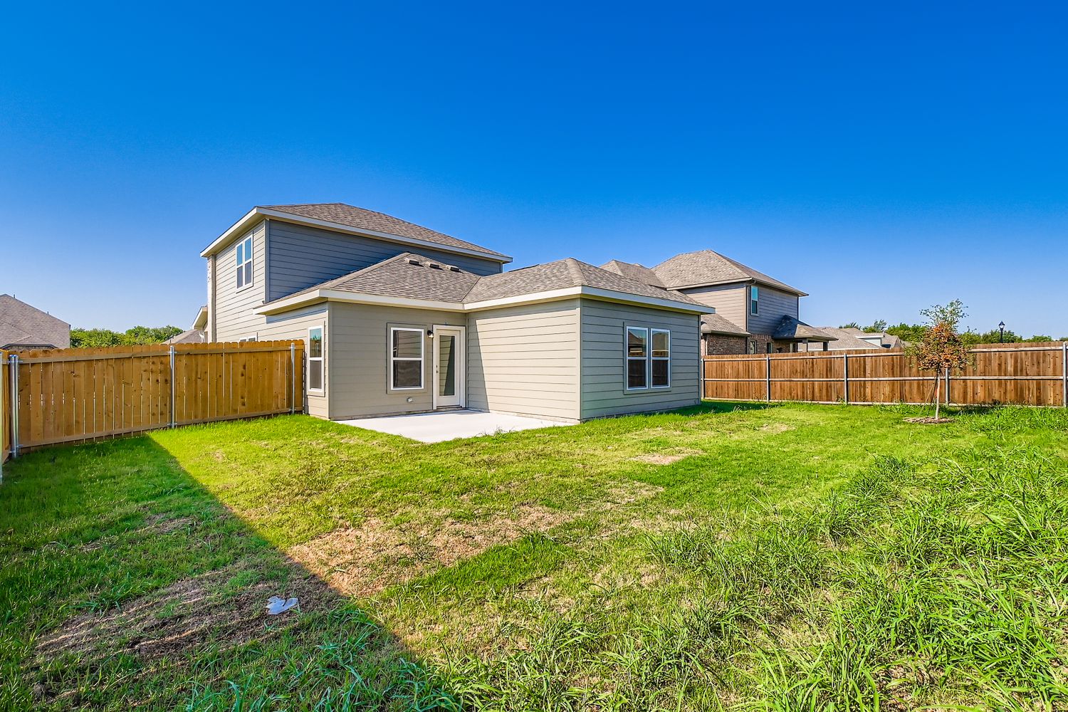 A house with a fence and grass.