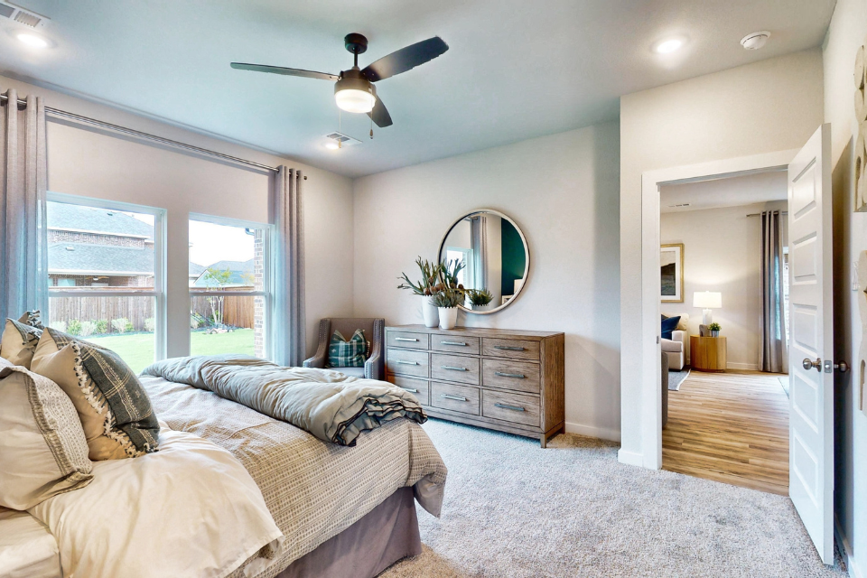 A bedroom with a large mirror.