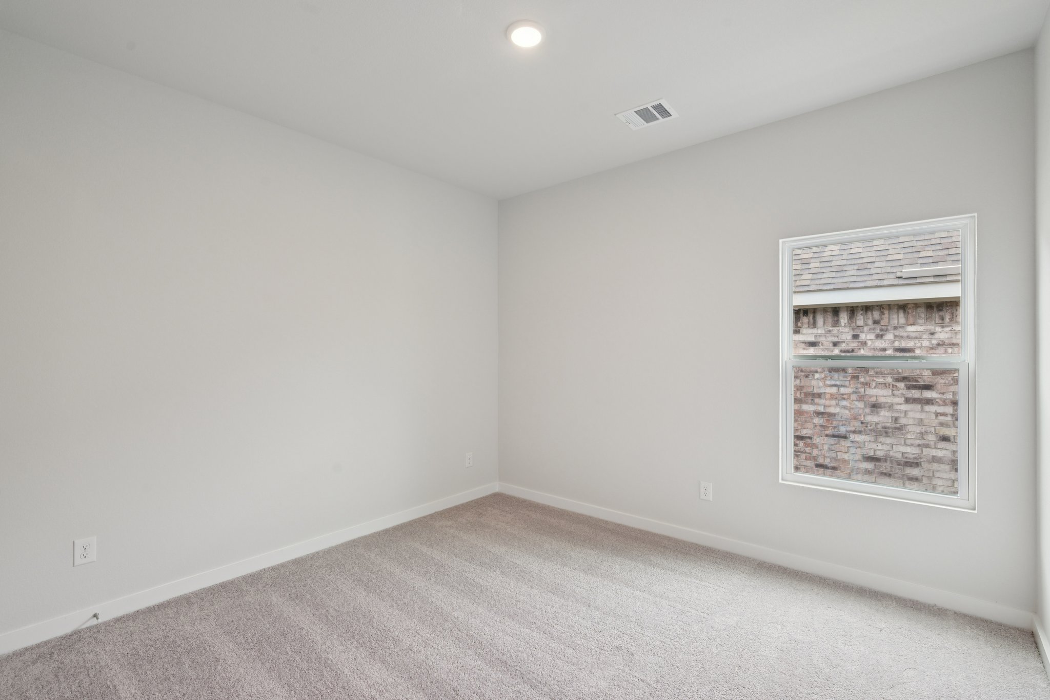 A white wall with a light on it.