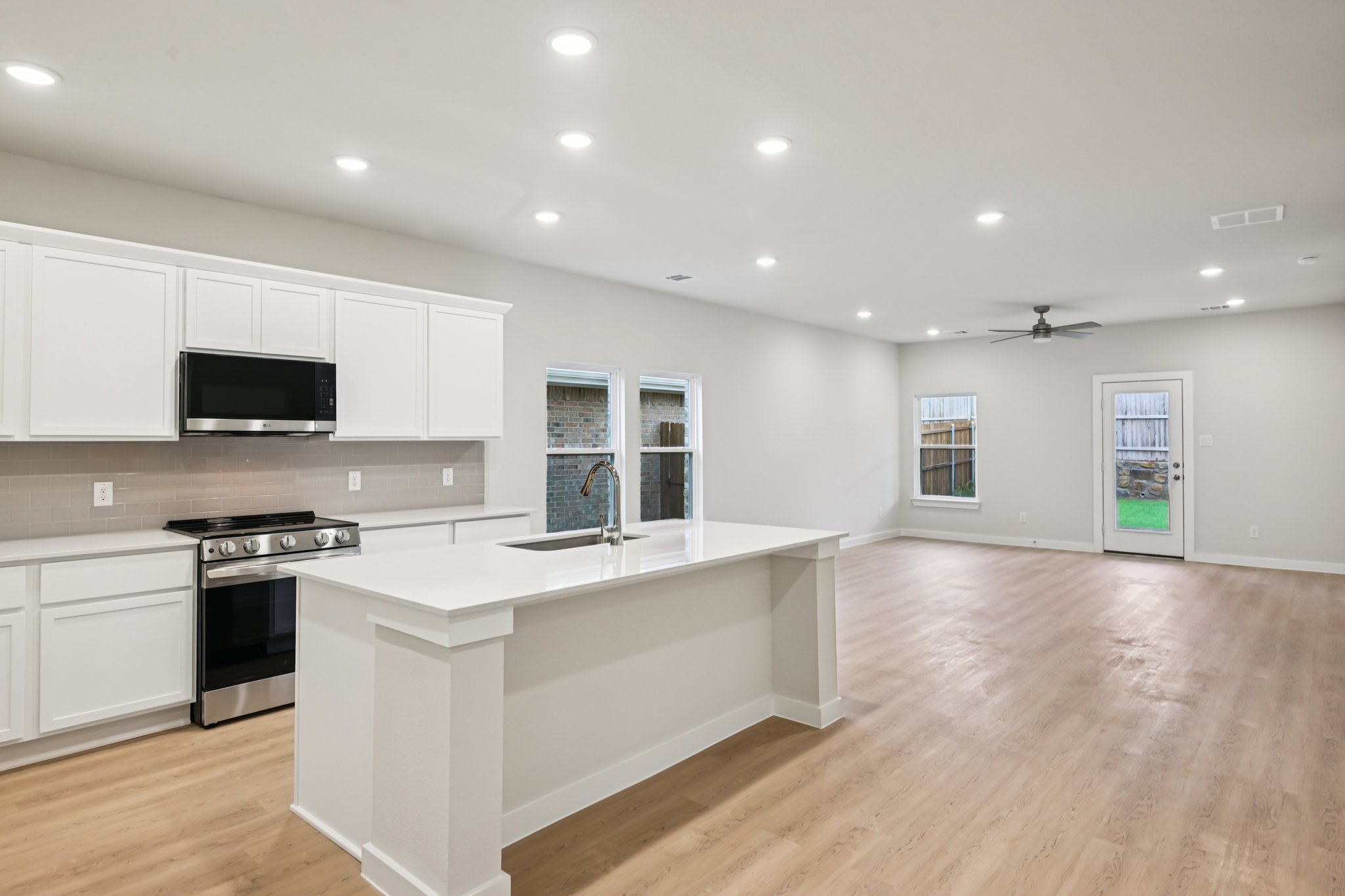 A kitchen with white cabinets.