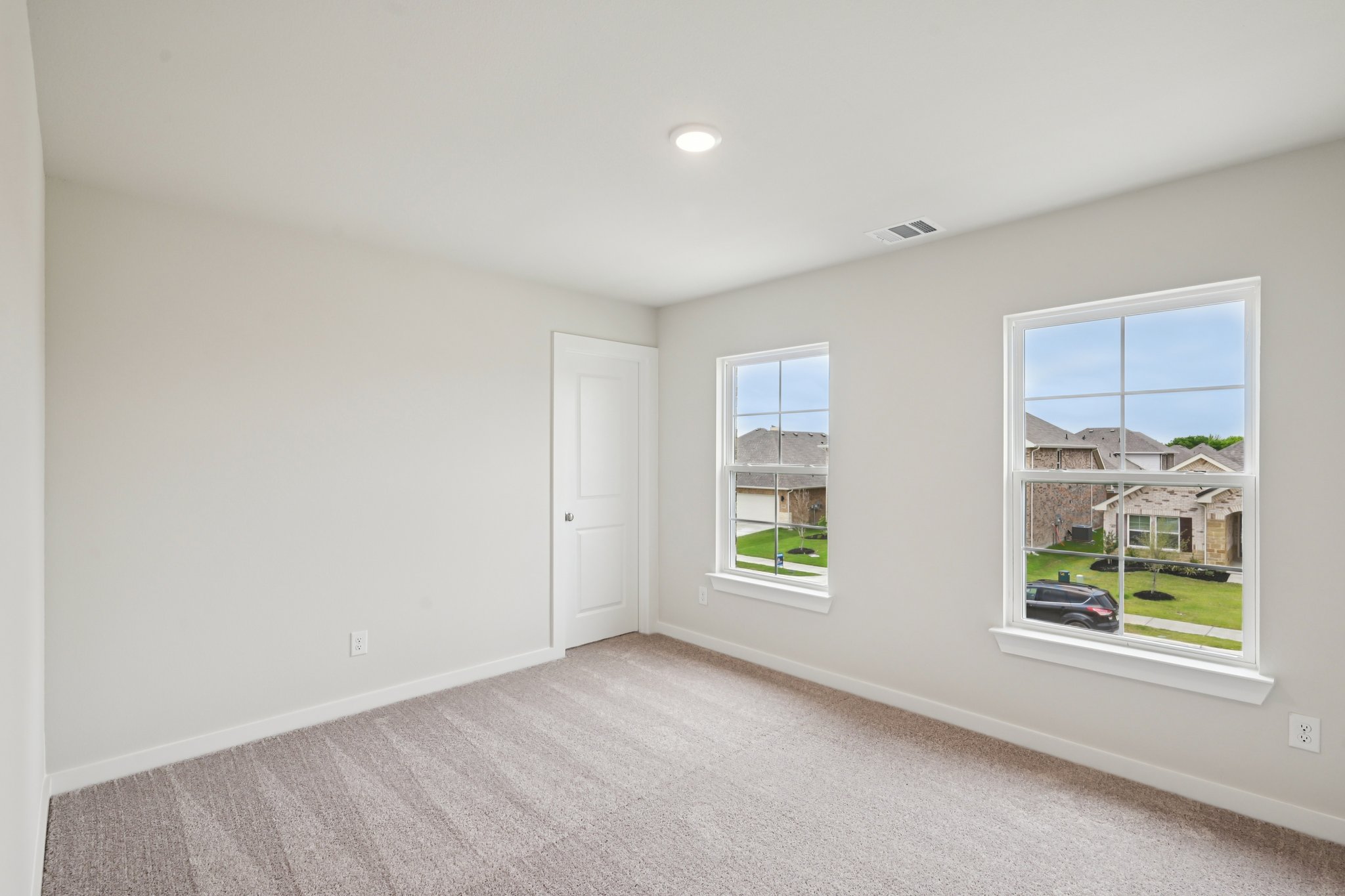 A room with a window and a door.