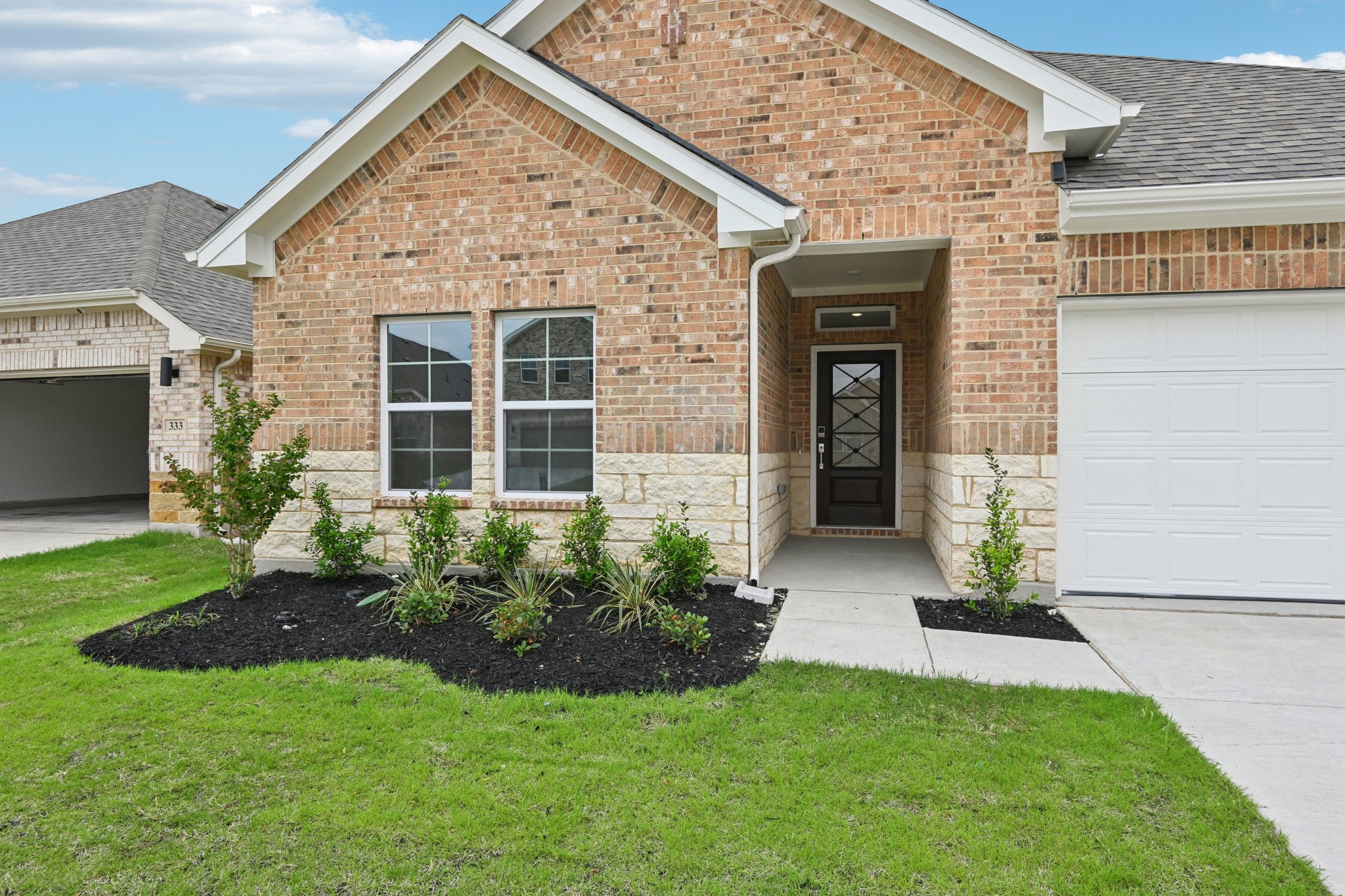 A brick house with a garage.