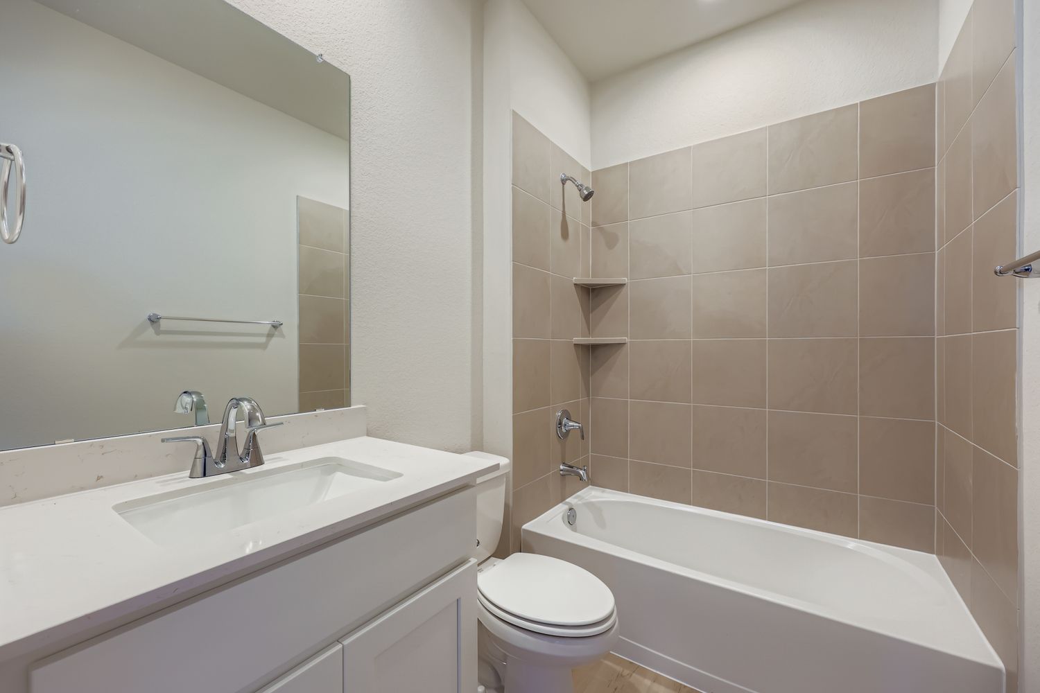 A bathroom with a tub sink and toilet.