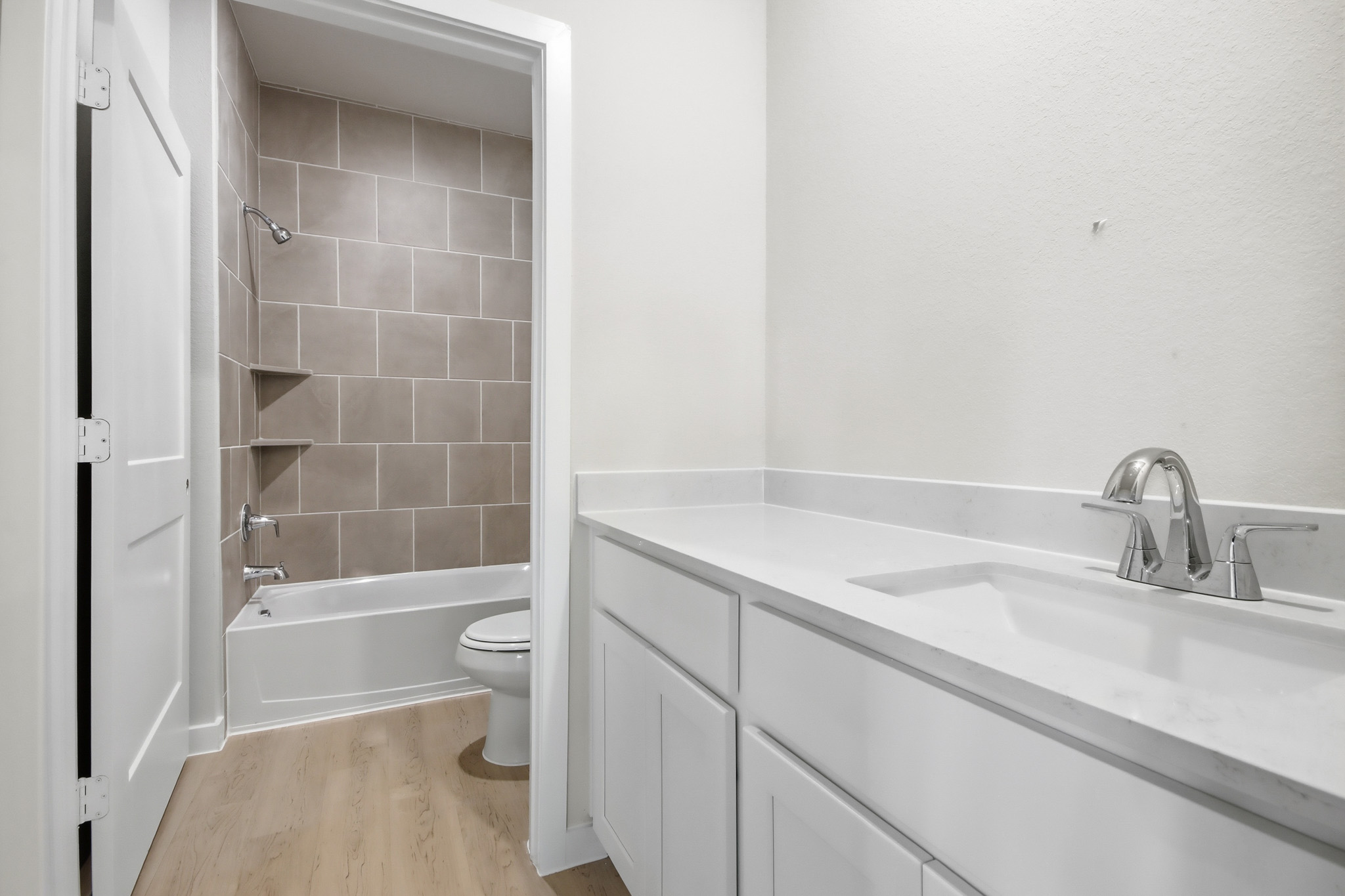 A bathroom with a tub sink and toilet.