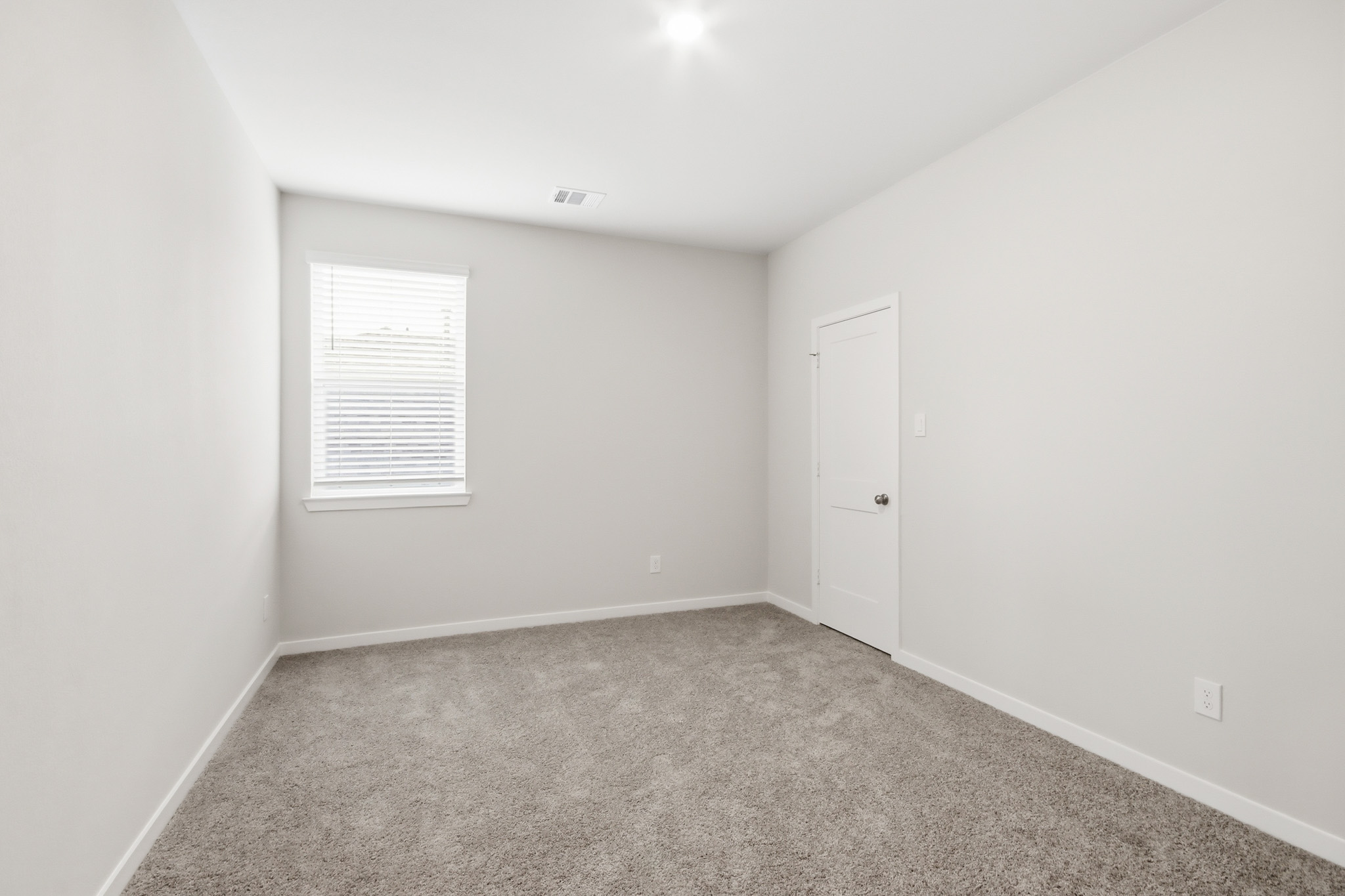 A room with a door and a window.
