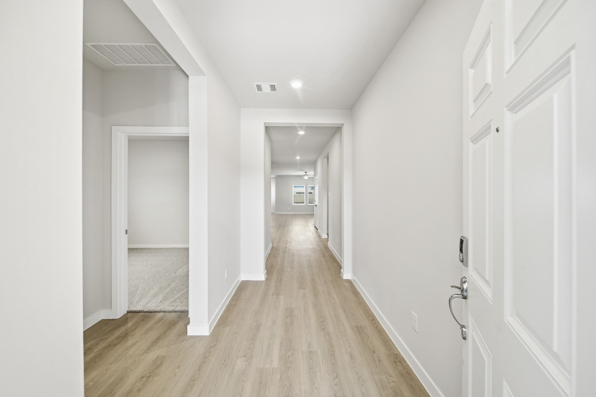 A hallway with white doors.