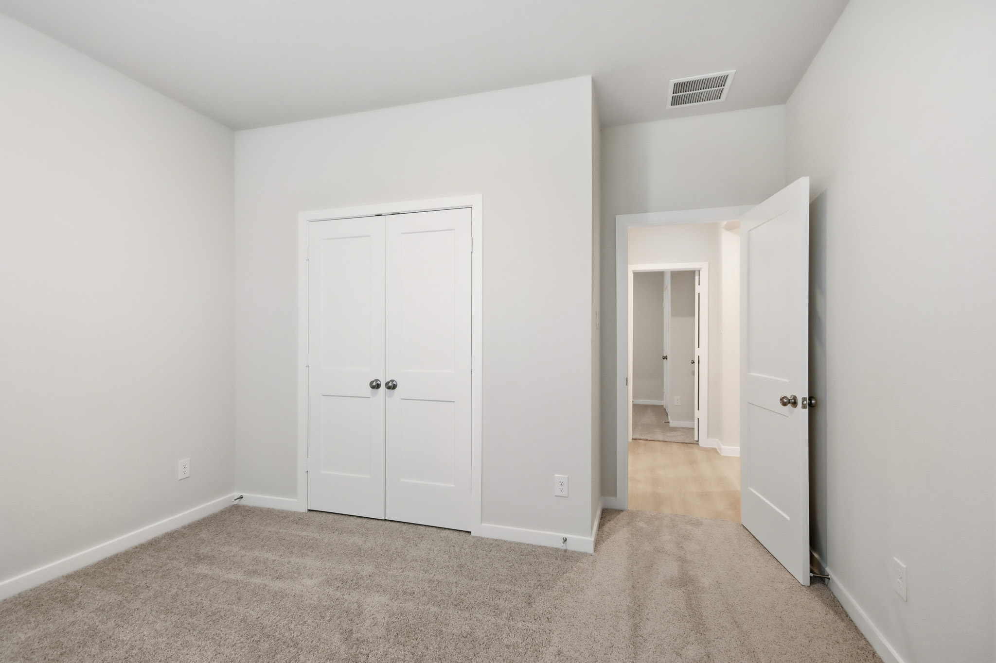 A hallway with white doors.