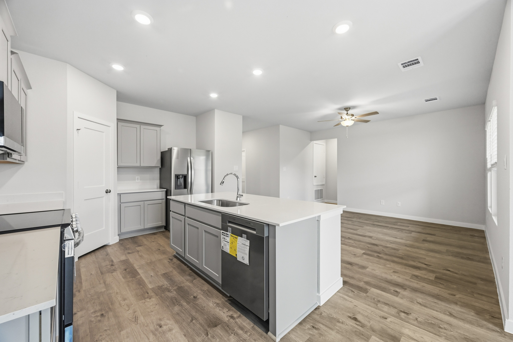 A kitchen with white cabinets.