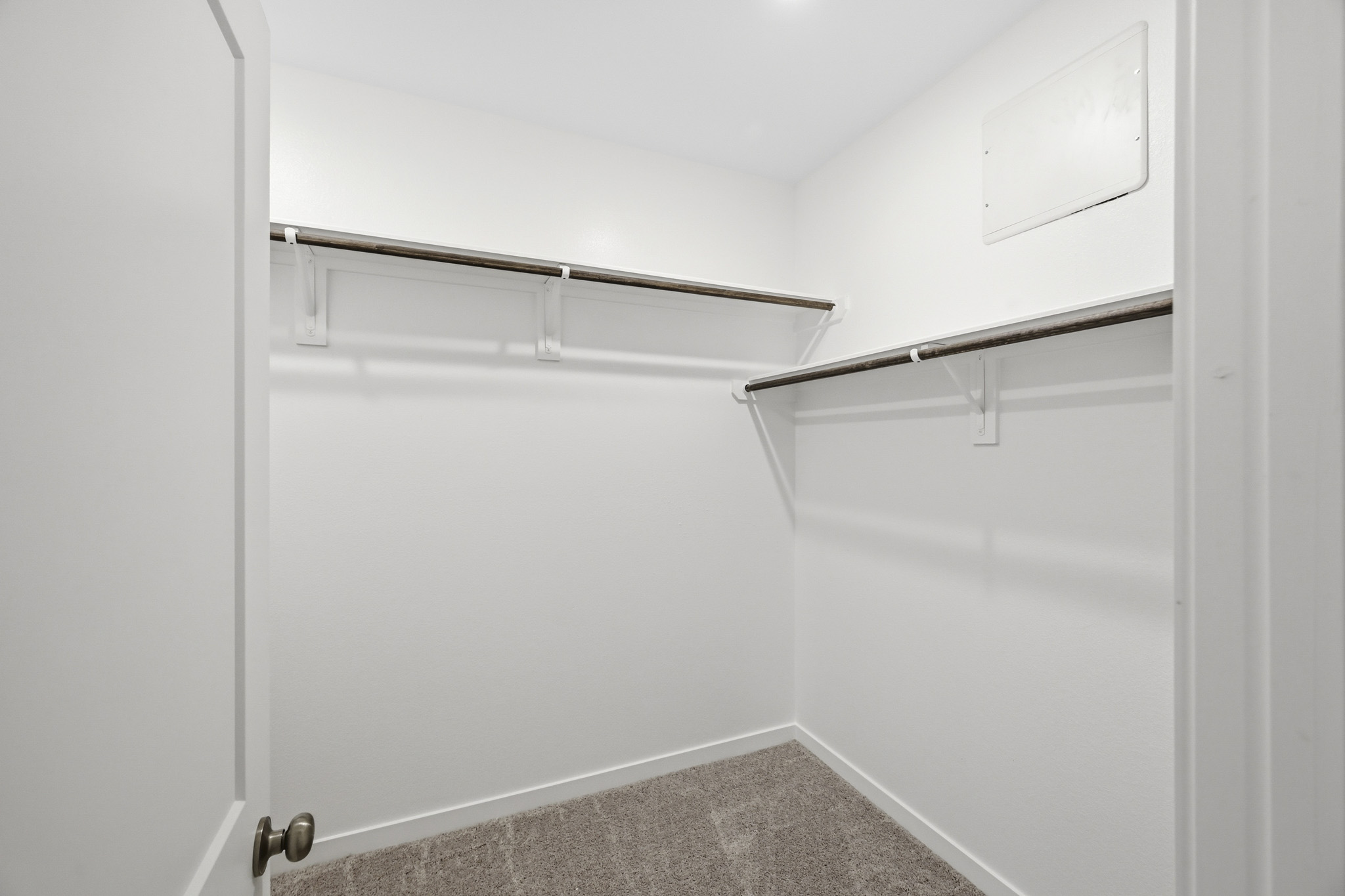 A white door with a metal bar.
