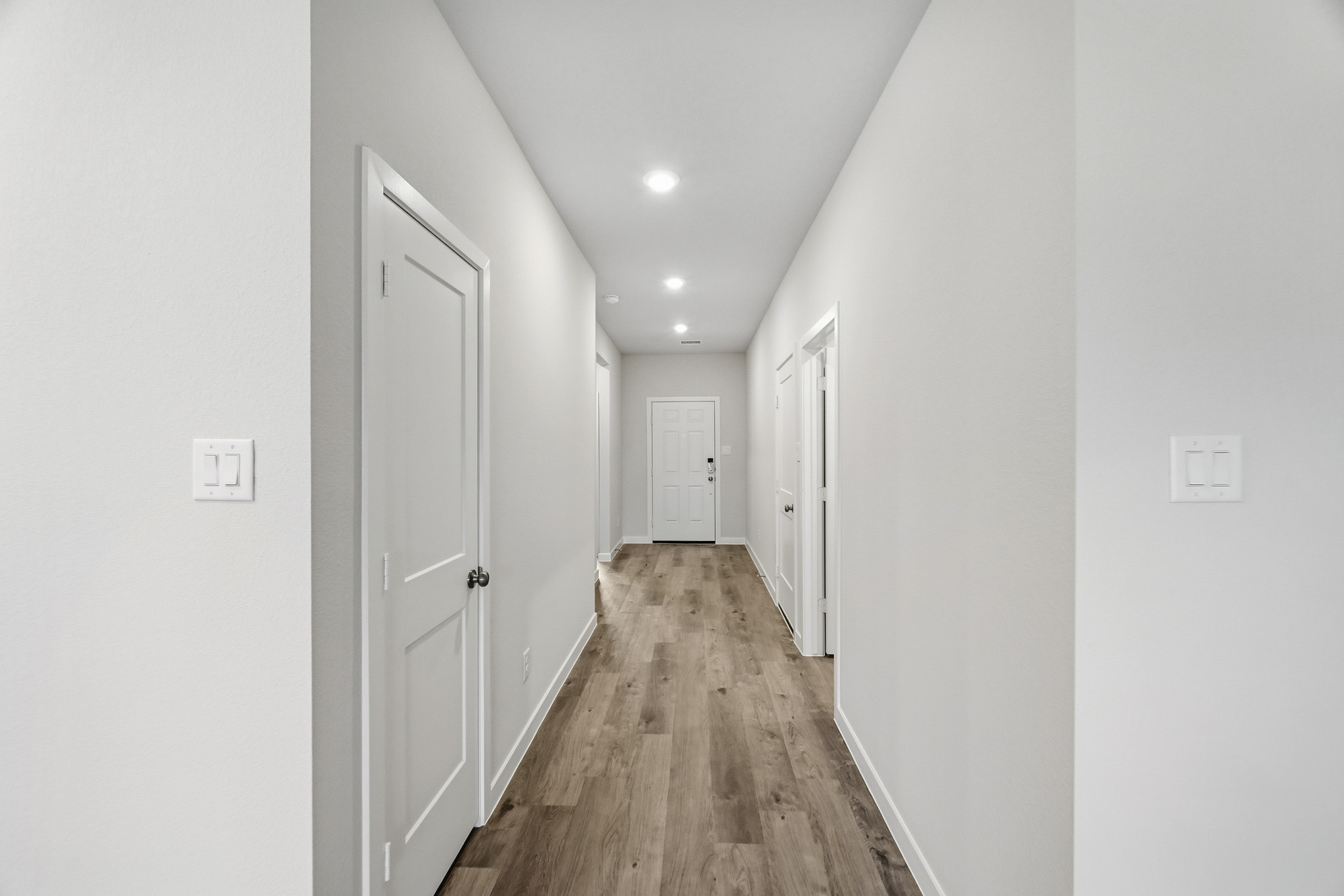 A hallway with white doors.