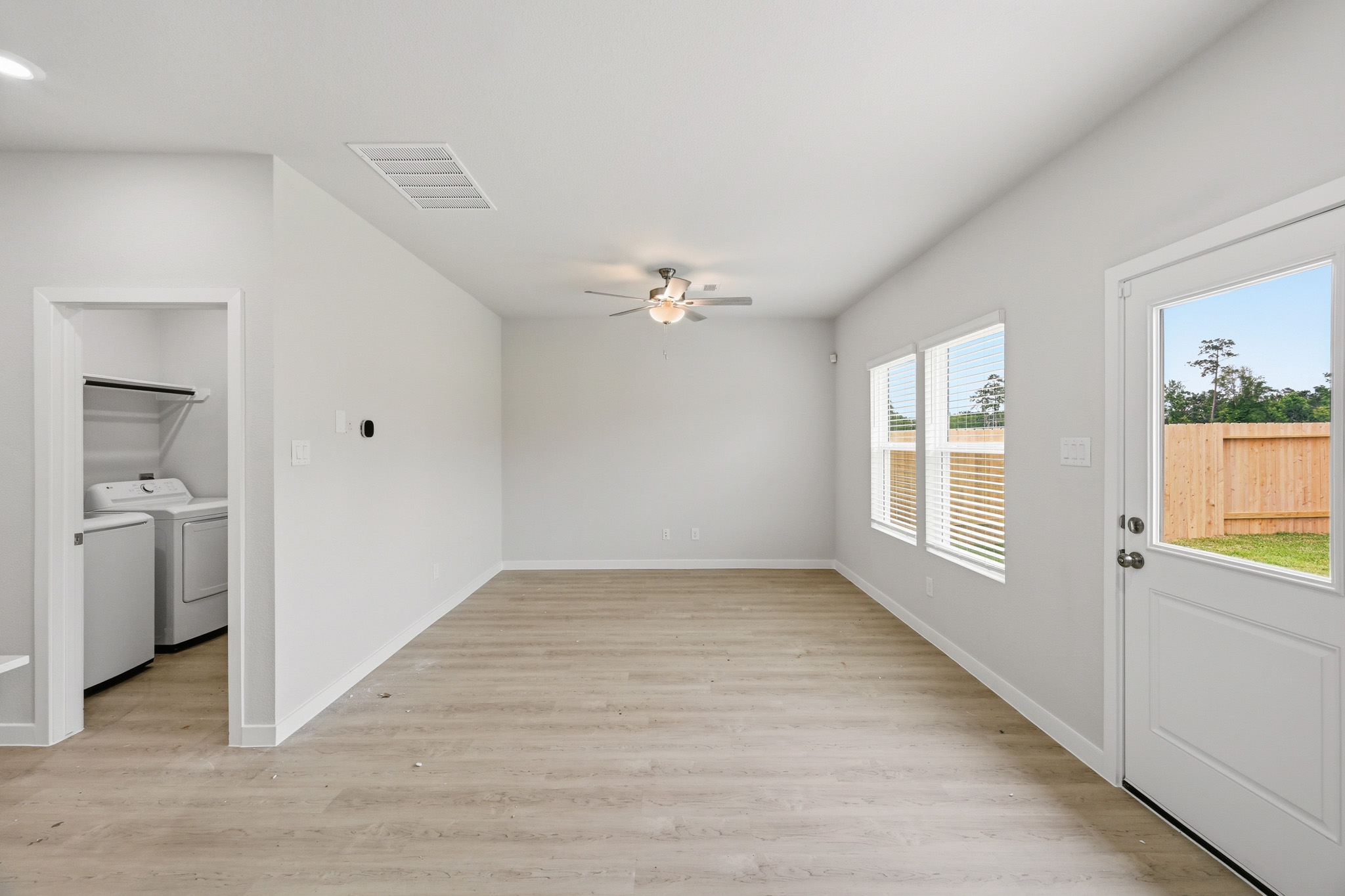 A room with a wood floor and white walls.