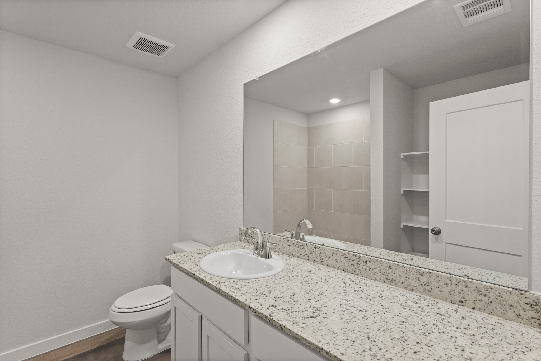A bathroom with a marble countertop.