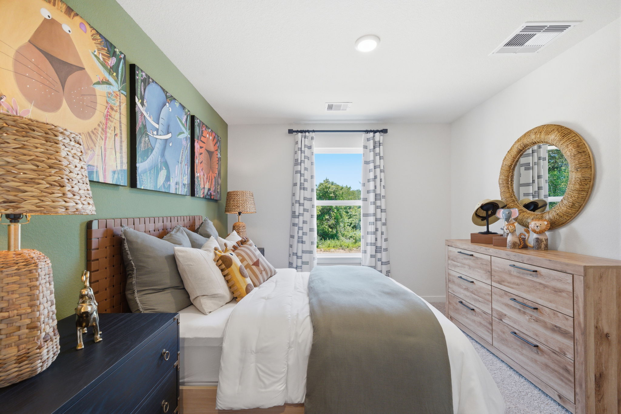 A bedroom with a bed and a dresser.