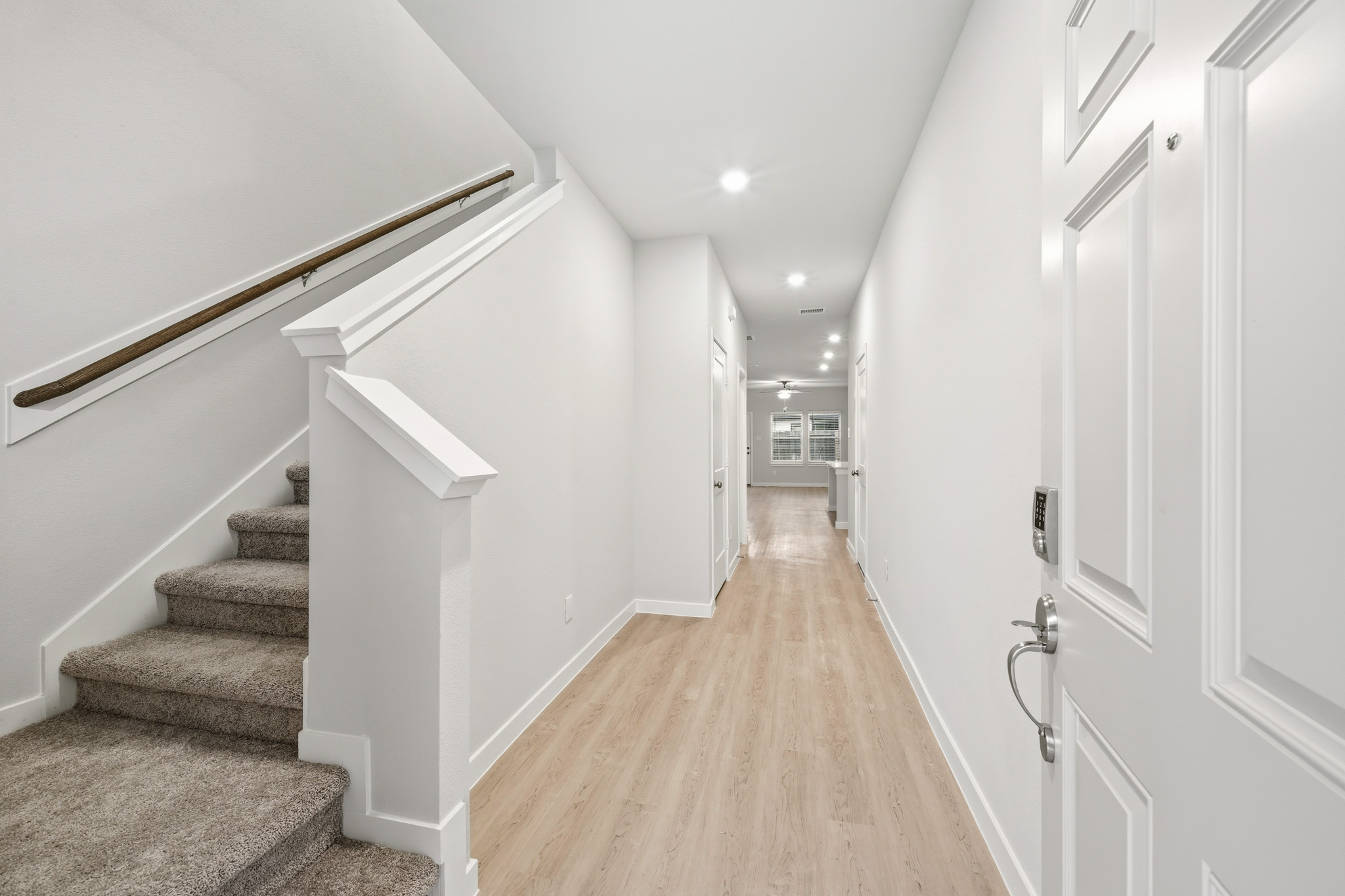 A hallway with white walls.