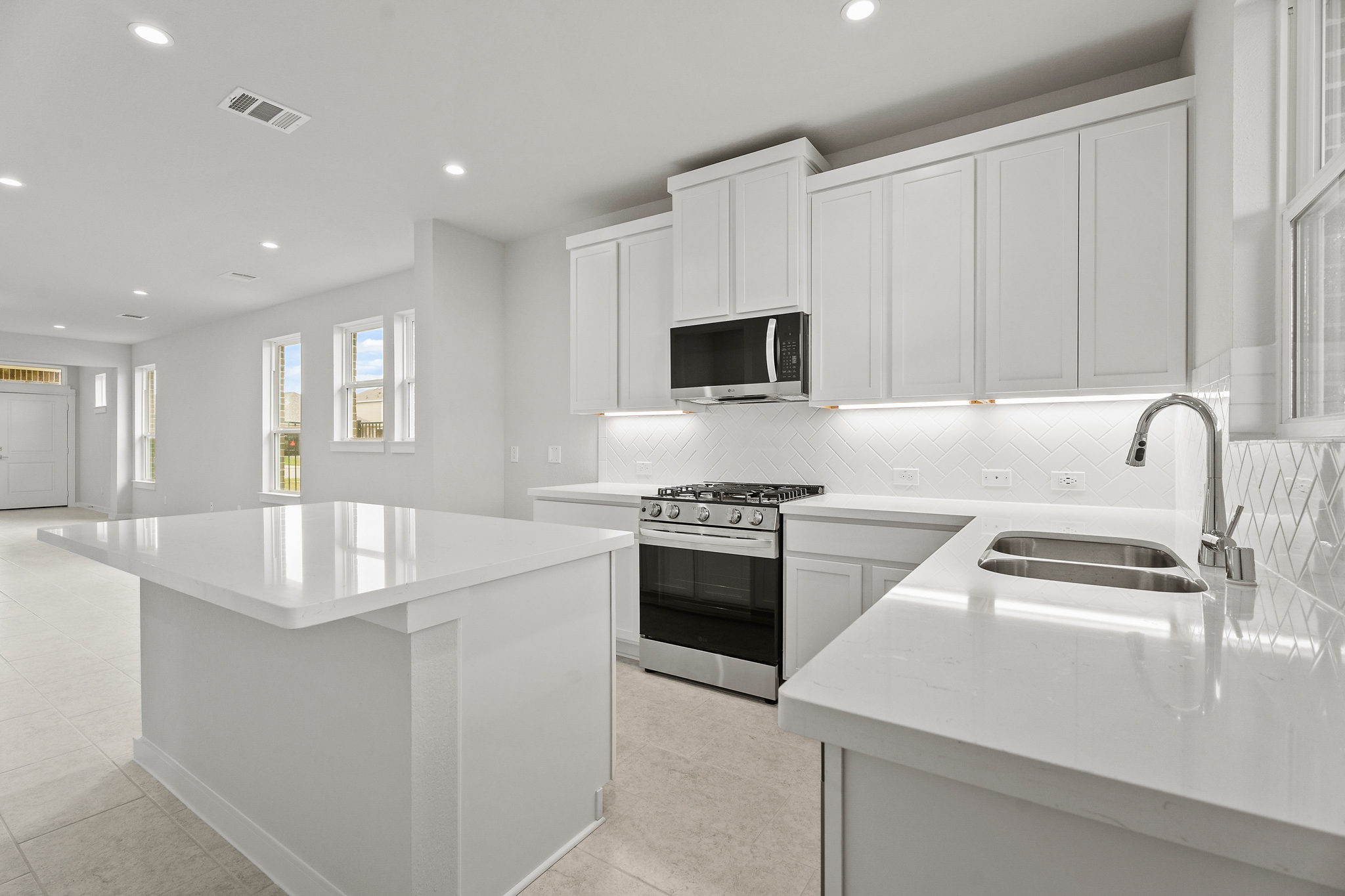 A kitchen with white cabinets.