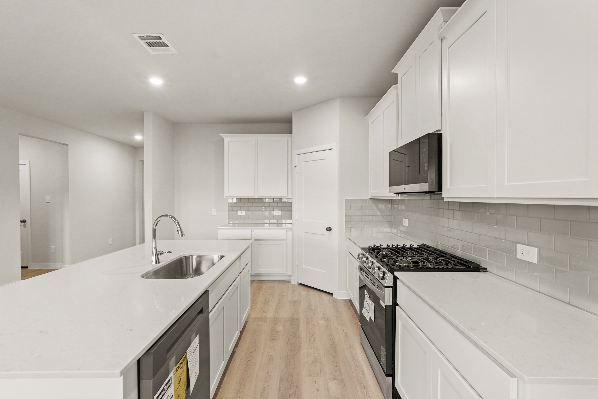 A kitchen with white cabinets.
