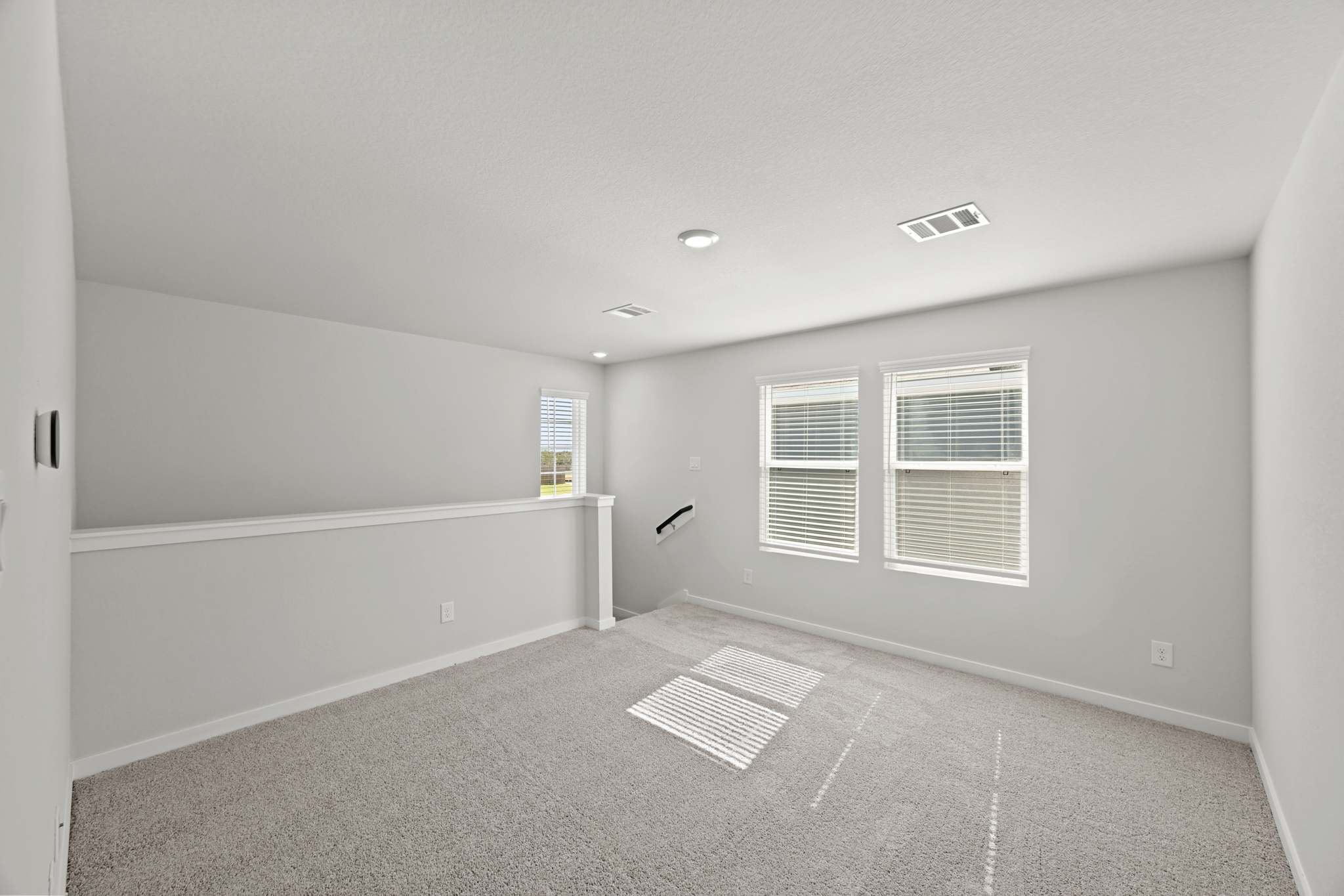 A room with a tile floor and a white wall with a vent.
