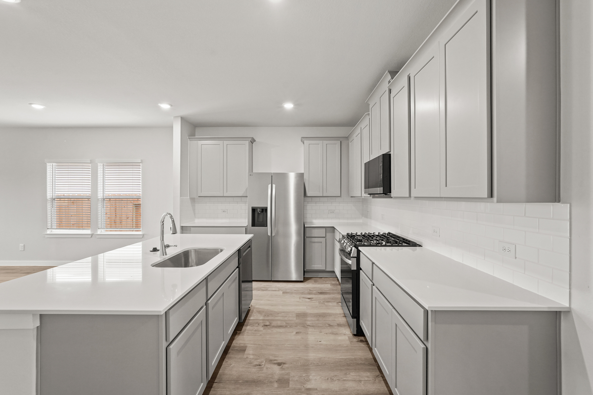 A kitchen with white cabinets.