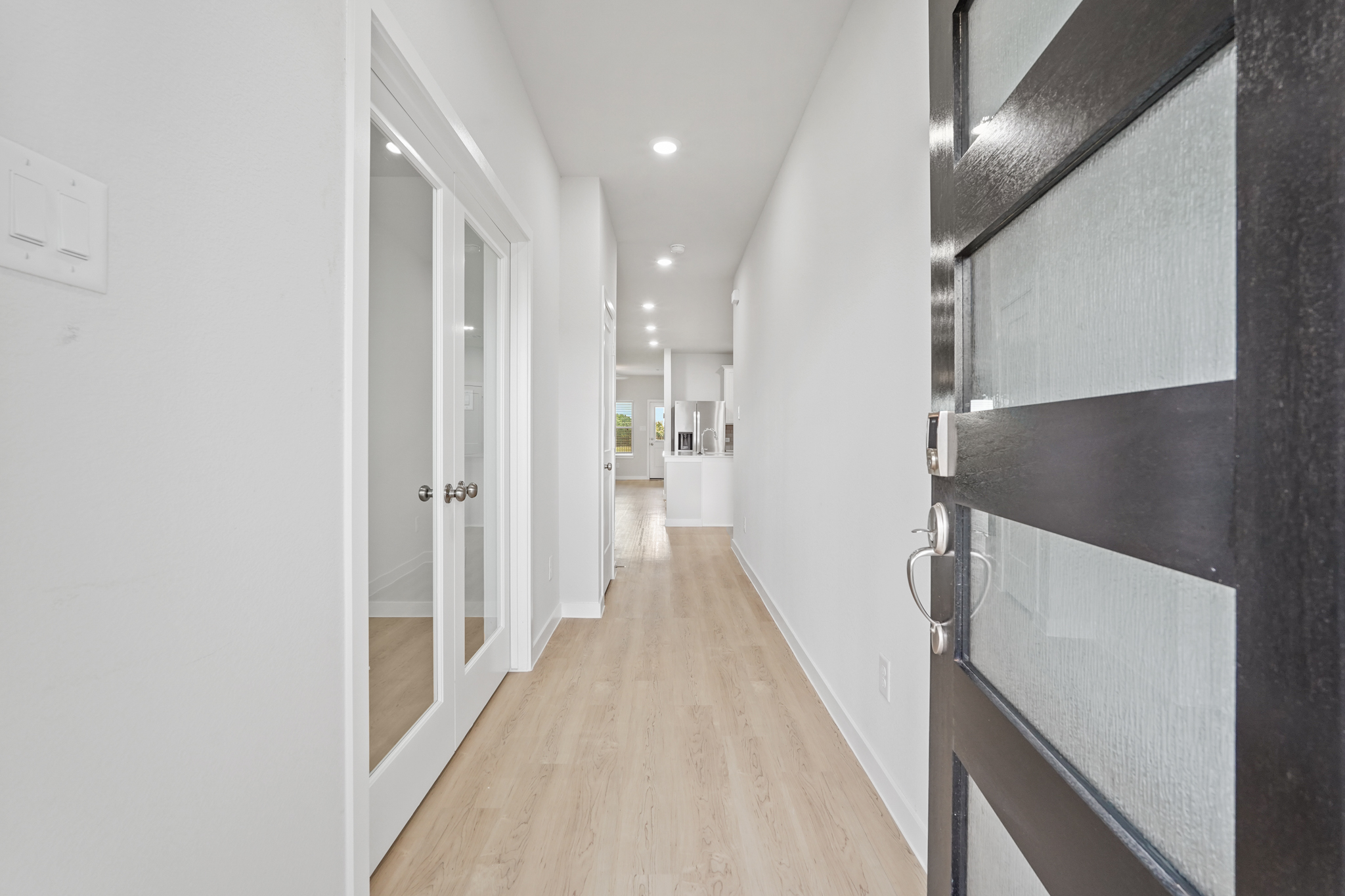 A hallway with white walls.