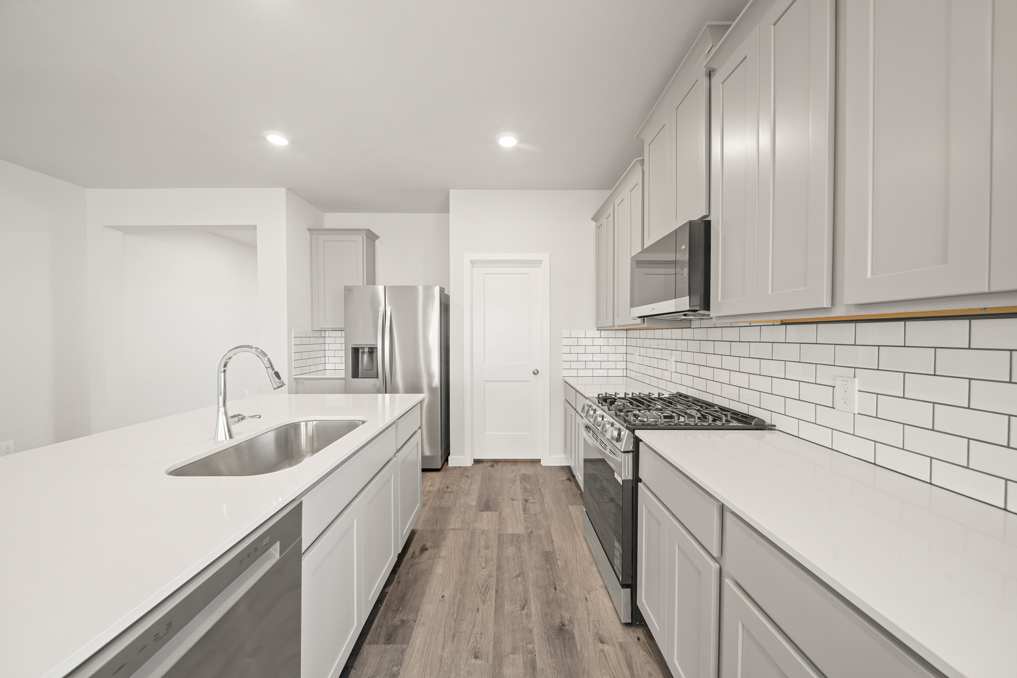 A kitchen with white cabinets.