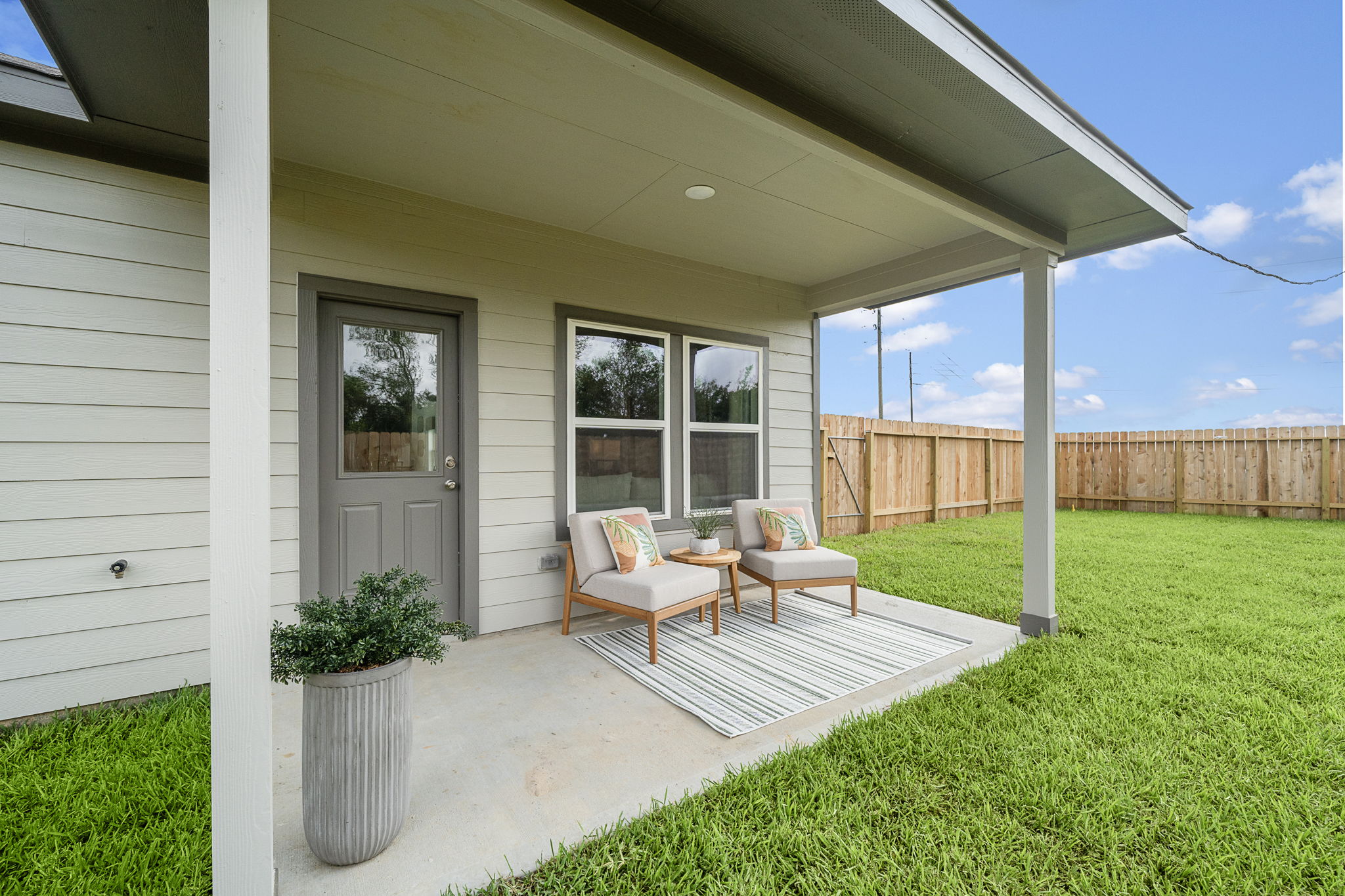 A house with a patio and a patio with a chair and a table.