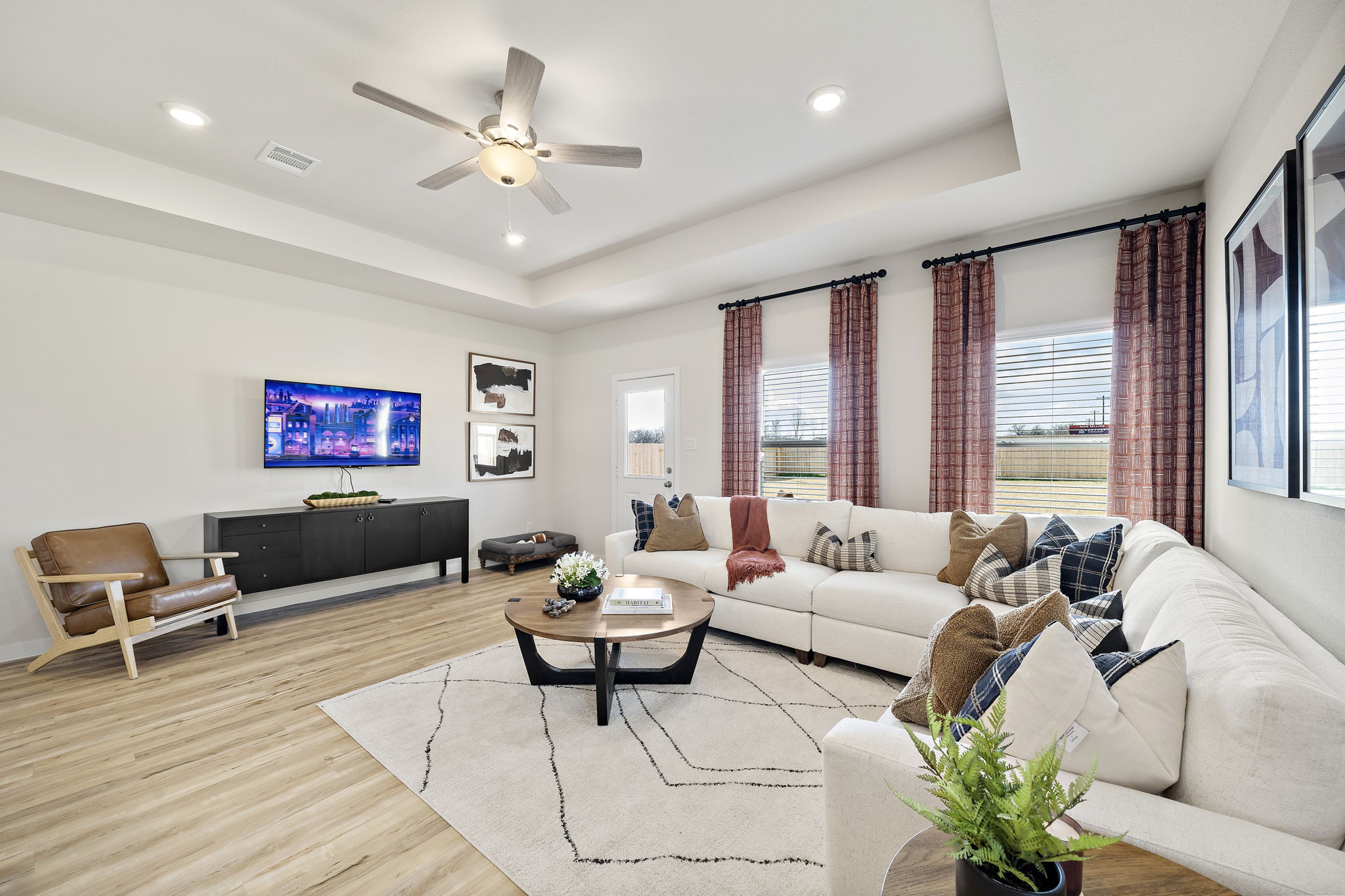 A living room with a large television.