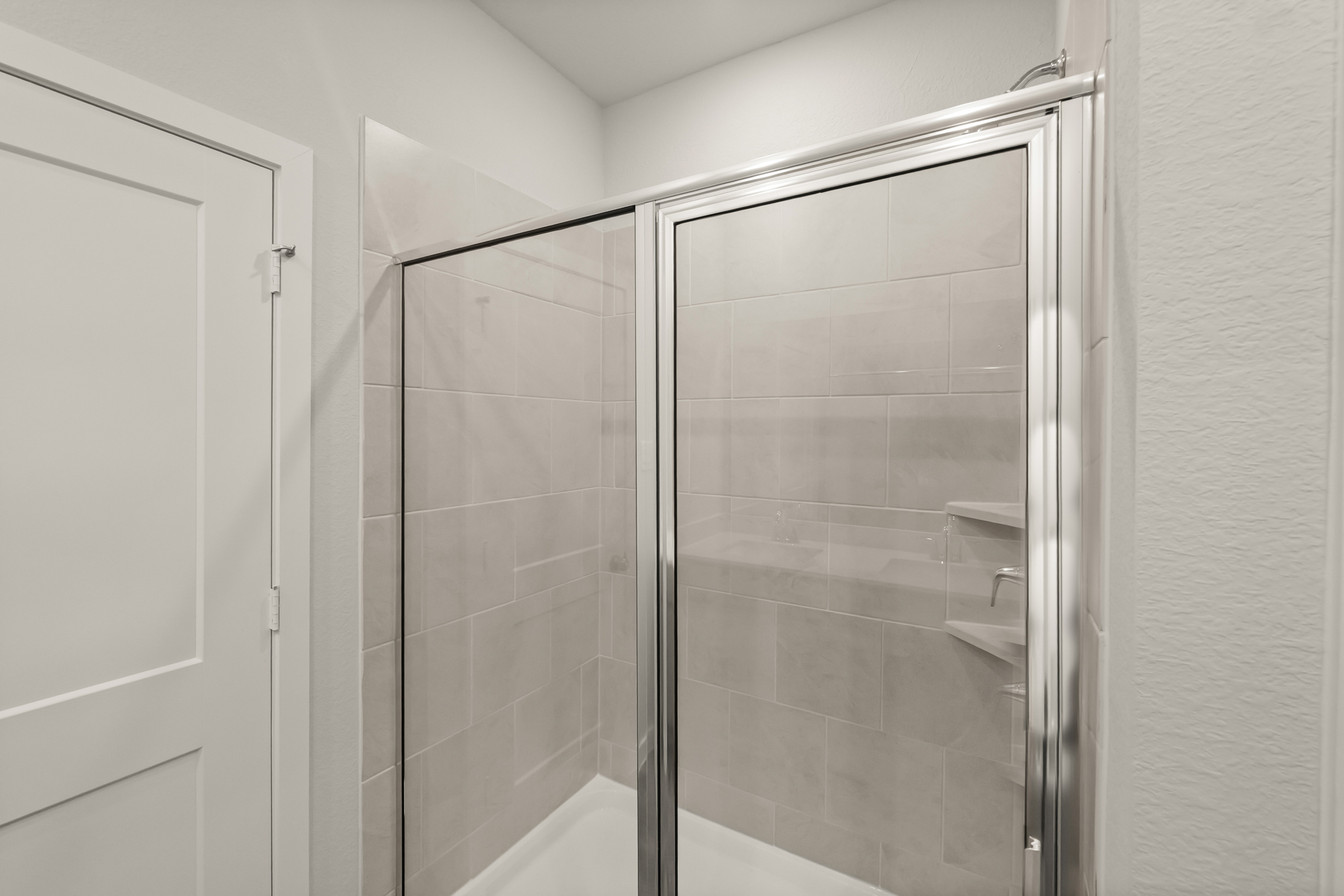 A shower with a glass door.