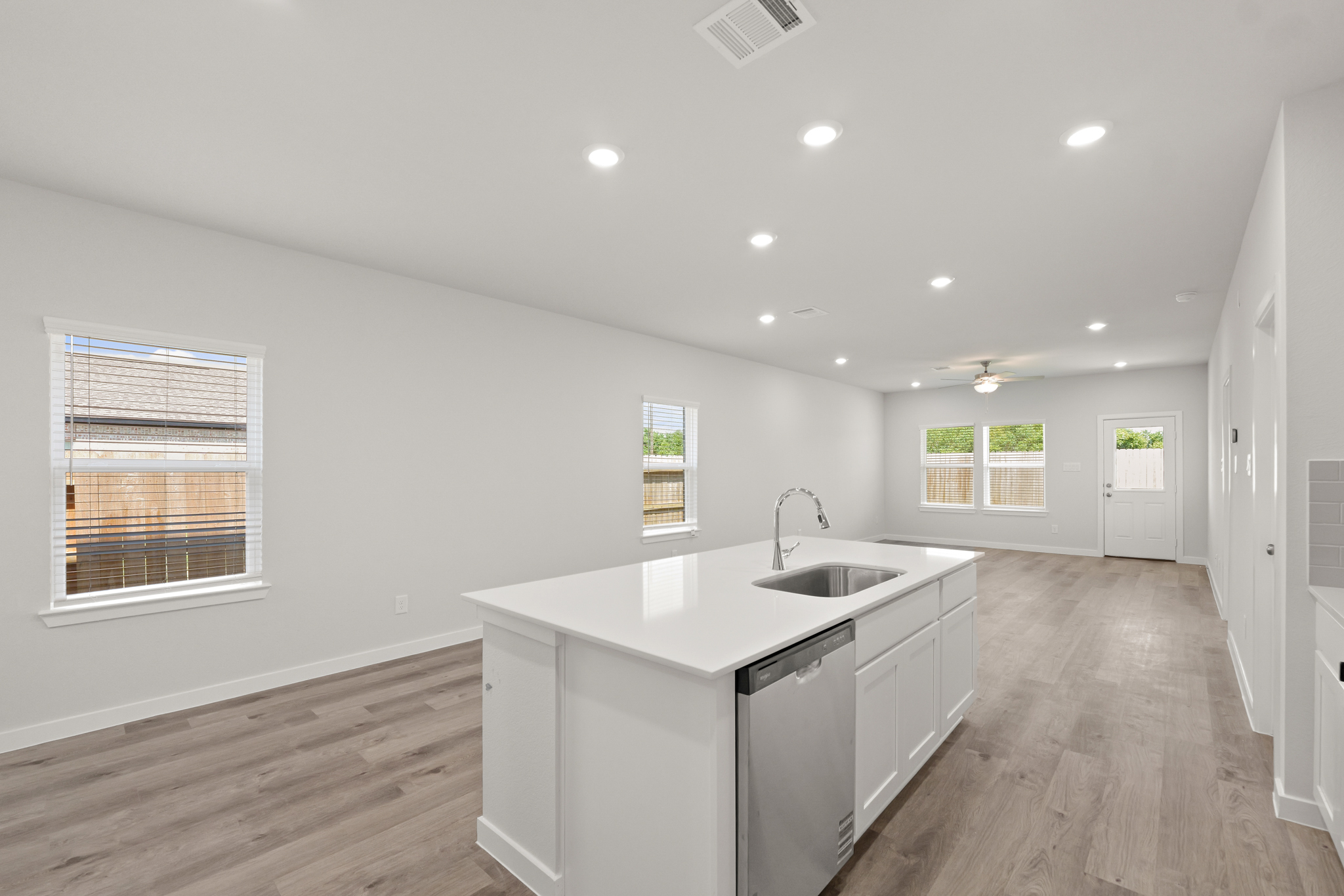 A kitchen with white cabinets.