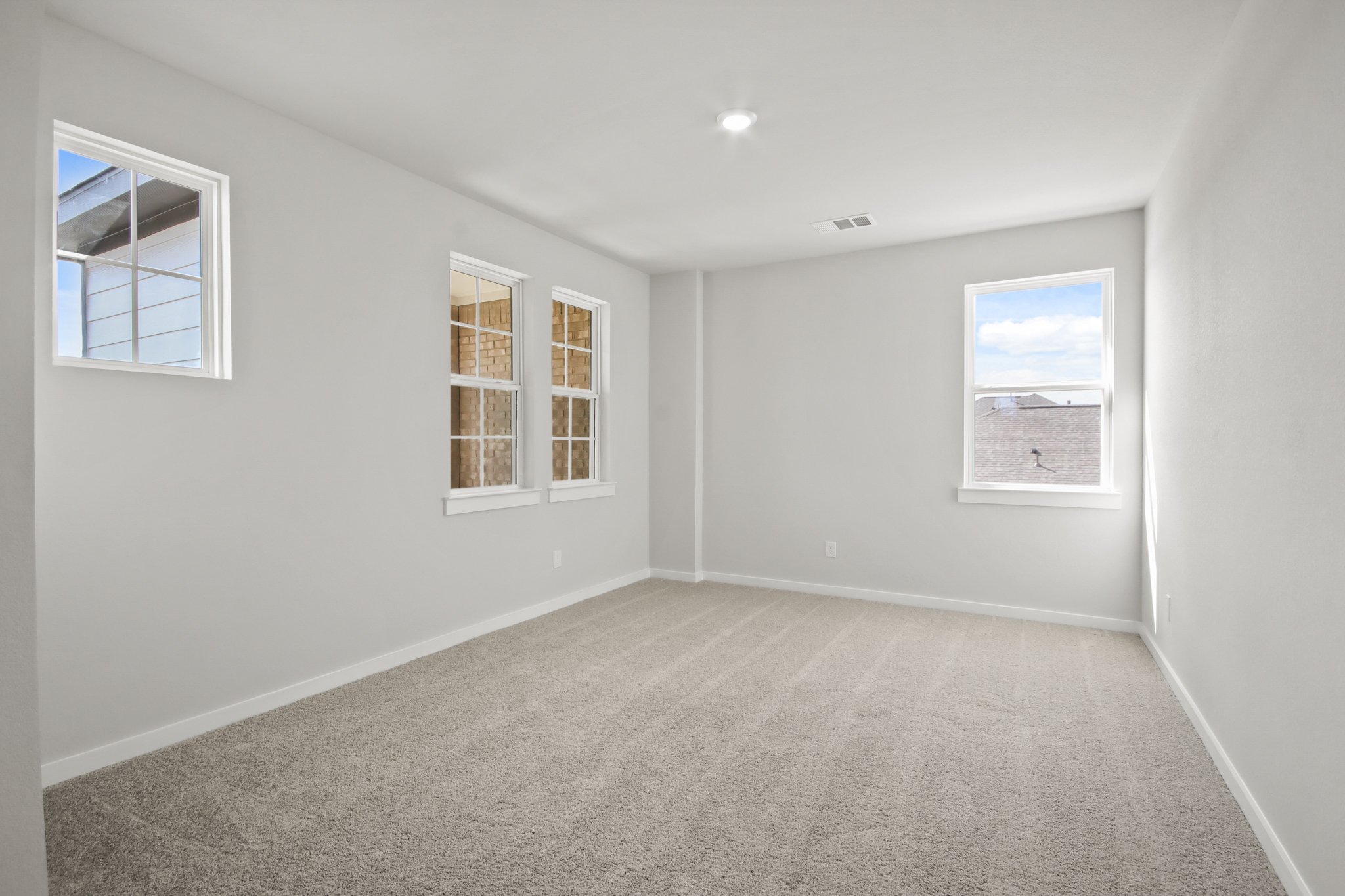 A room with a window and a rug.