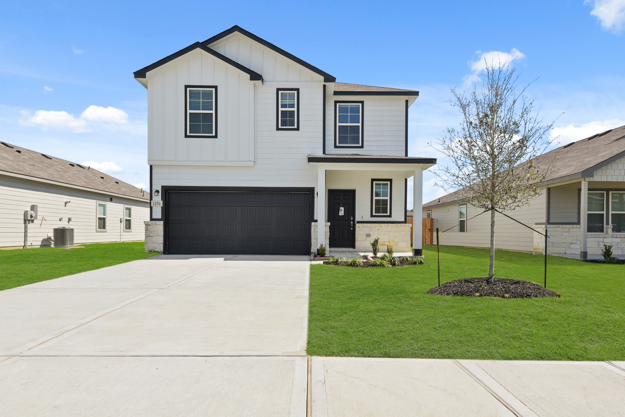 A white house with a driveway.