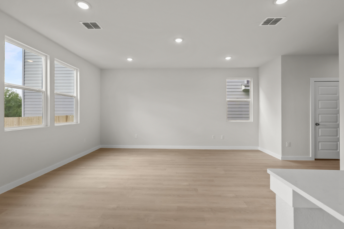 A room with a wood floor and white walls.