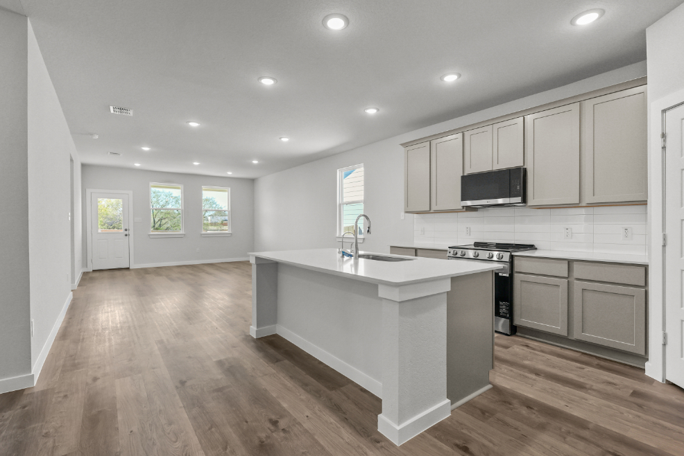 A kitchen with white cabinets.