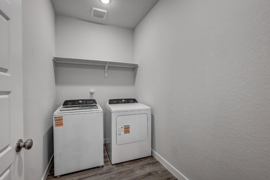 A small kitchen with a washer and dryer.