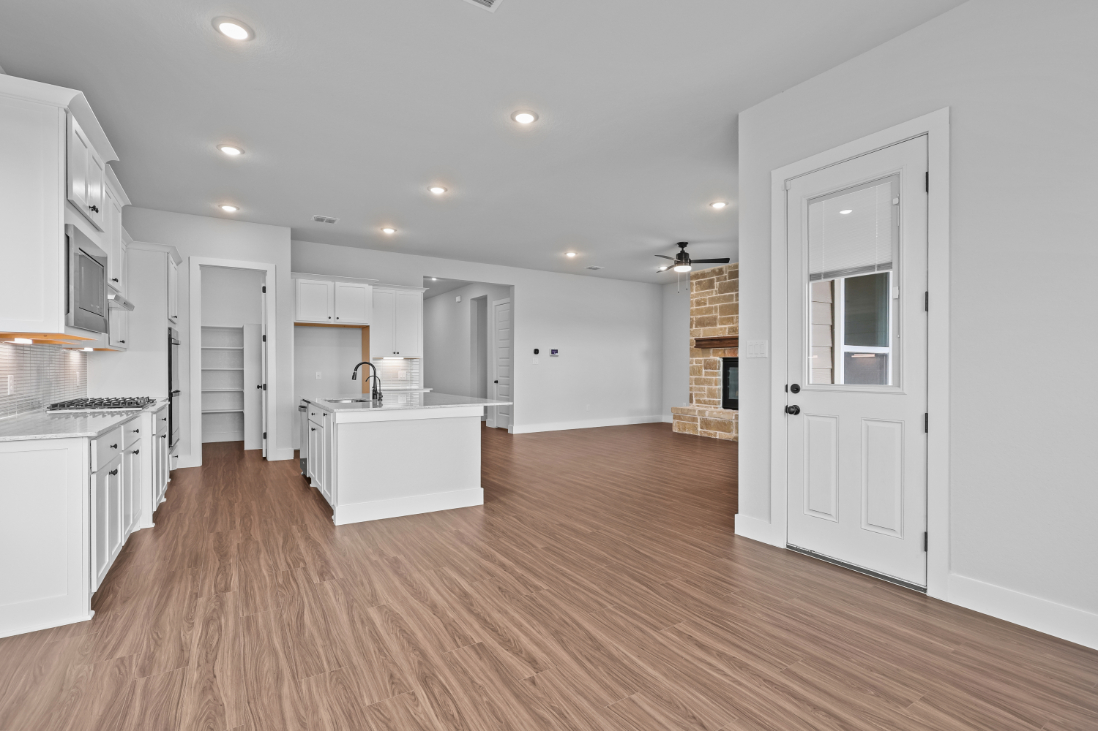 A kitchen with white cabinets.