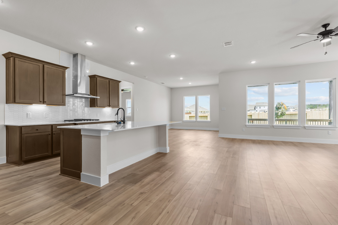 A kitchen with a wood floor.