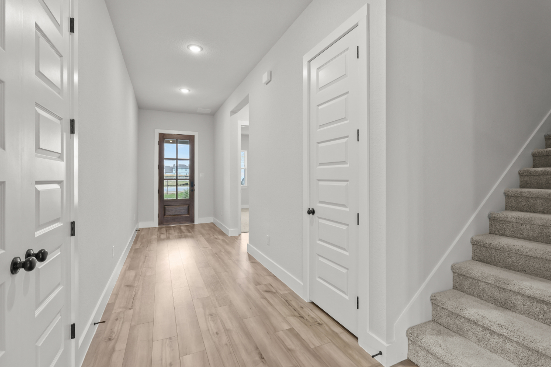 A hallway with white doors.