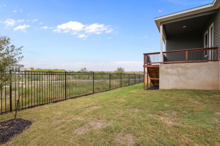 A fenced in yard next to a house.