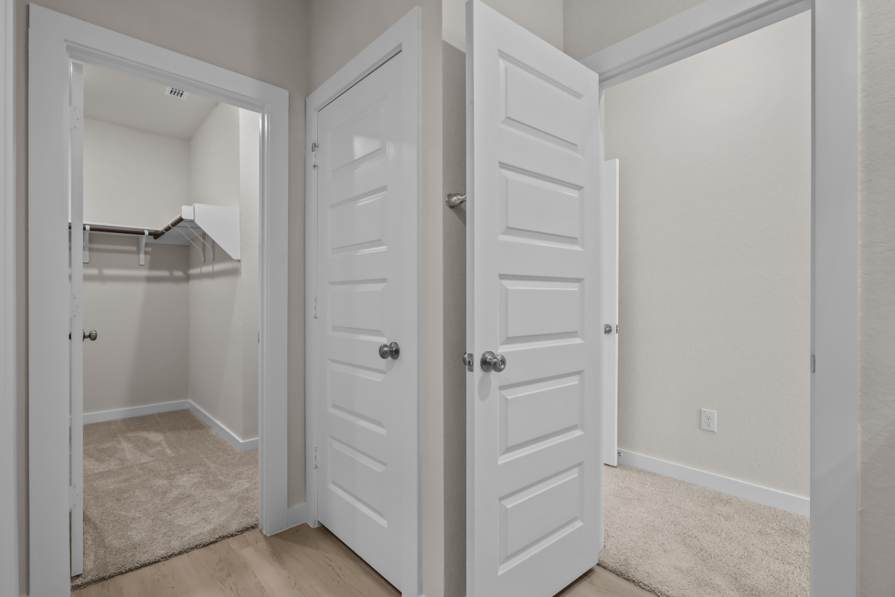 A white closet with a door open.