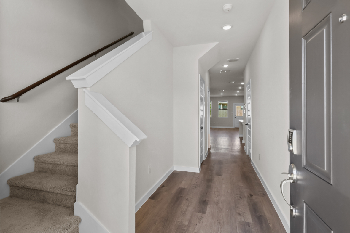 A hallway with white walls.