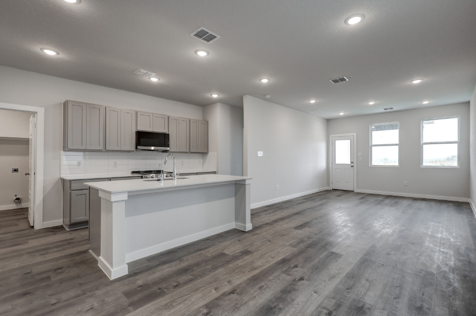 A kitchen with white cabinets.