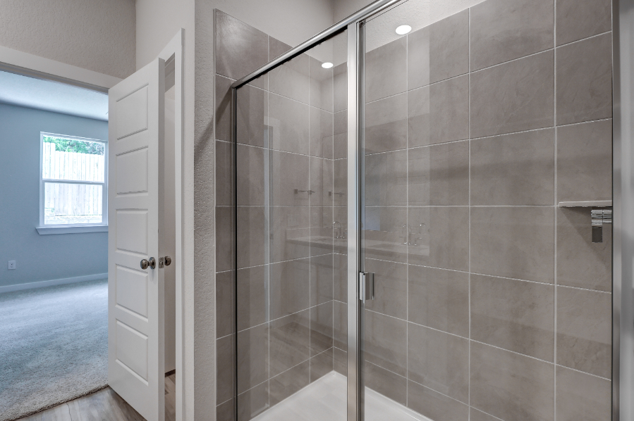 A shower with a glass door.