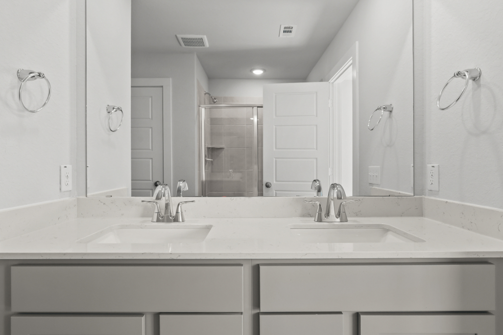 A bathroom with a large mirror.