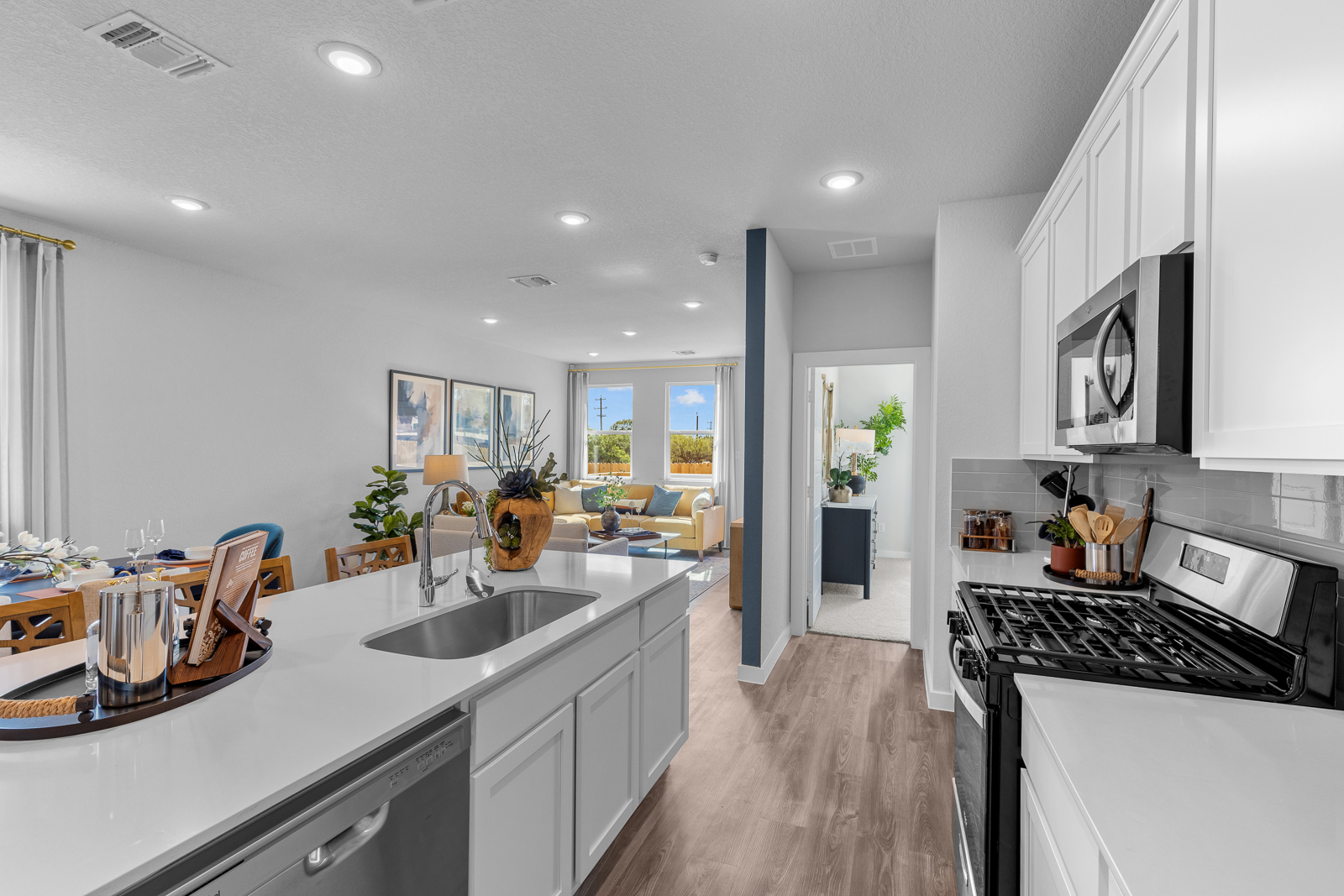 A kitchen with white cabinets.