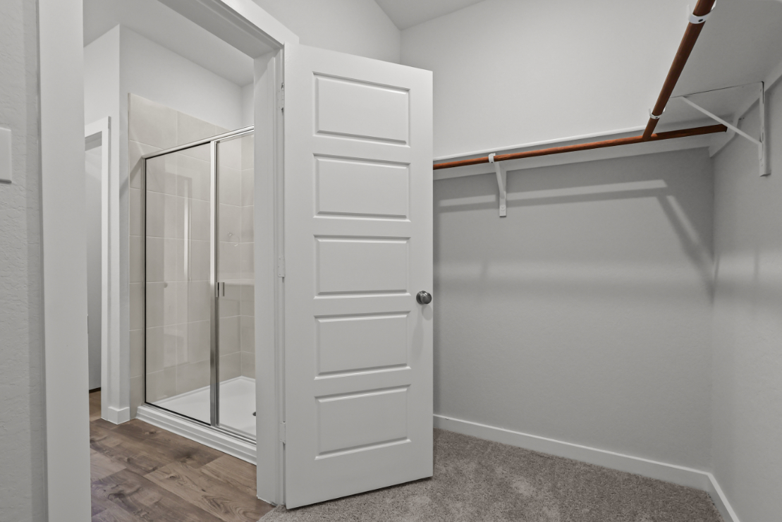 A white closet with a glass door.