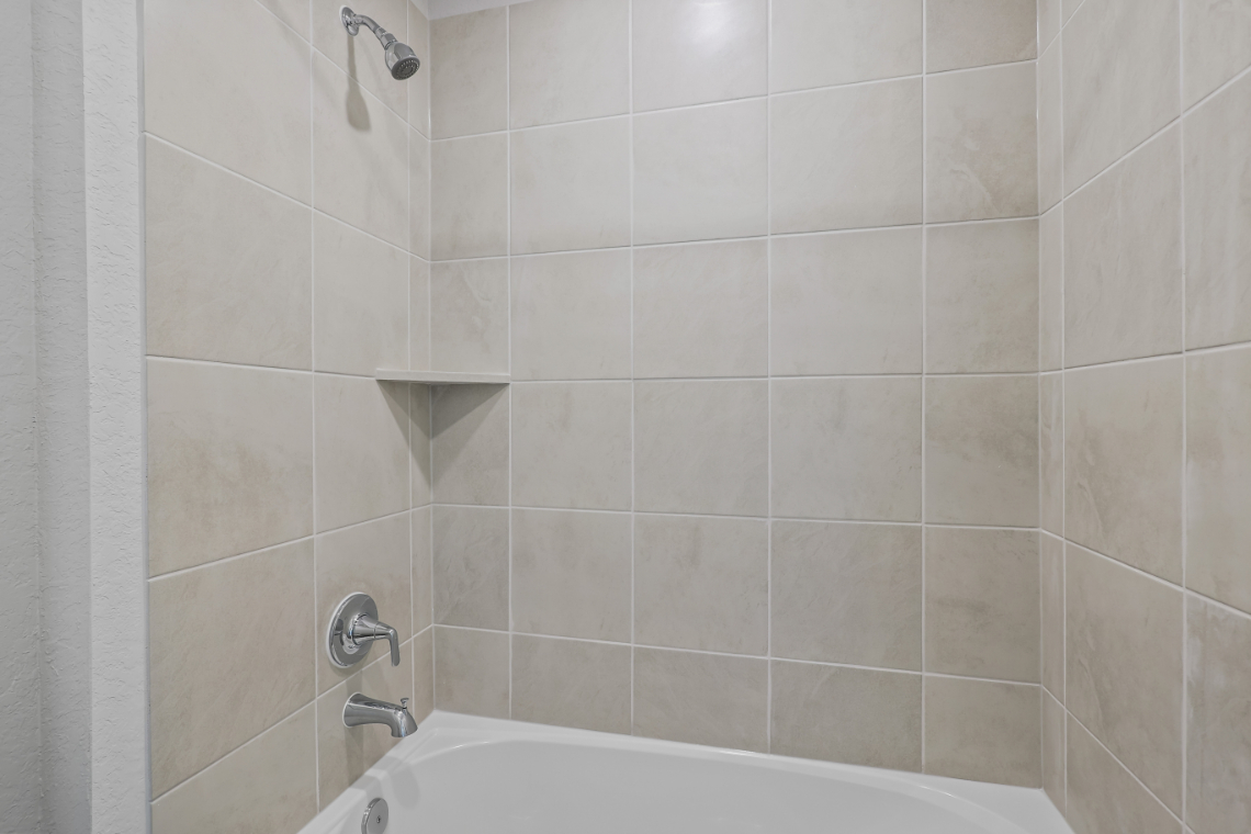 A bathtub and a shower unit.