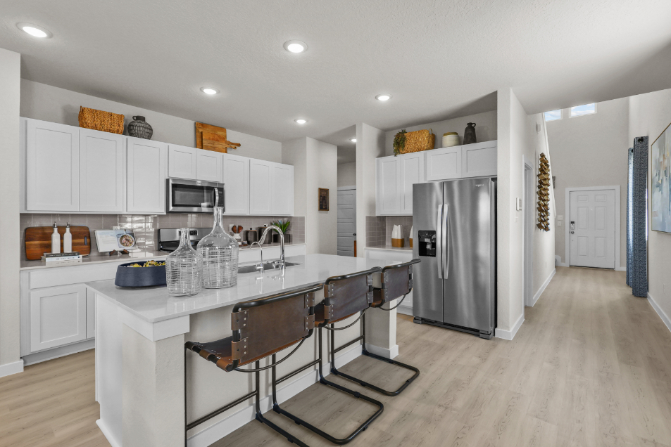 A kitchen with white cabinets.