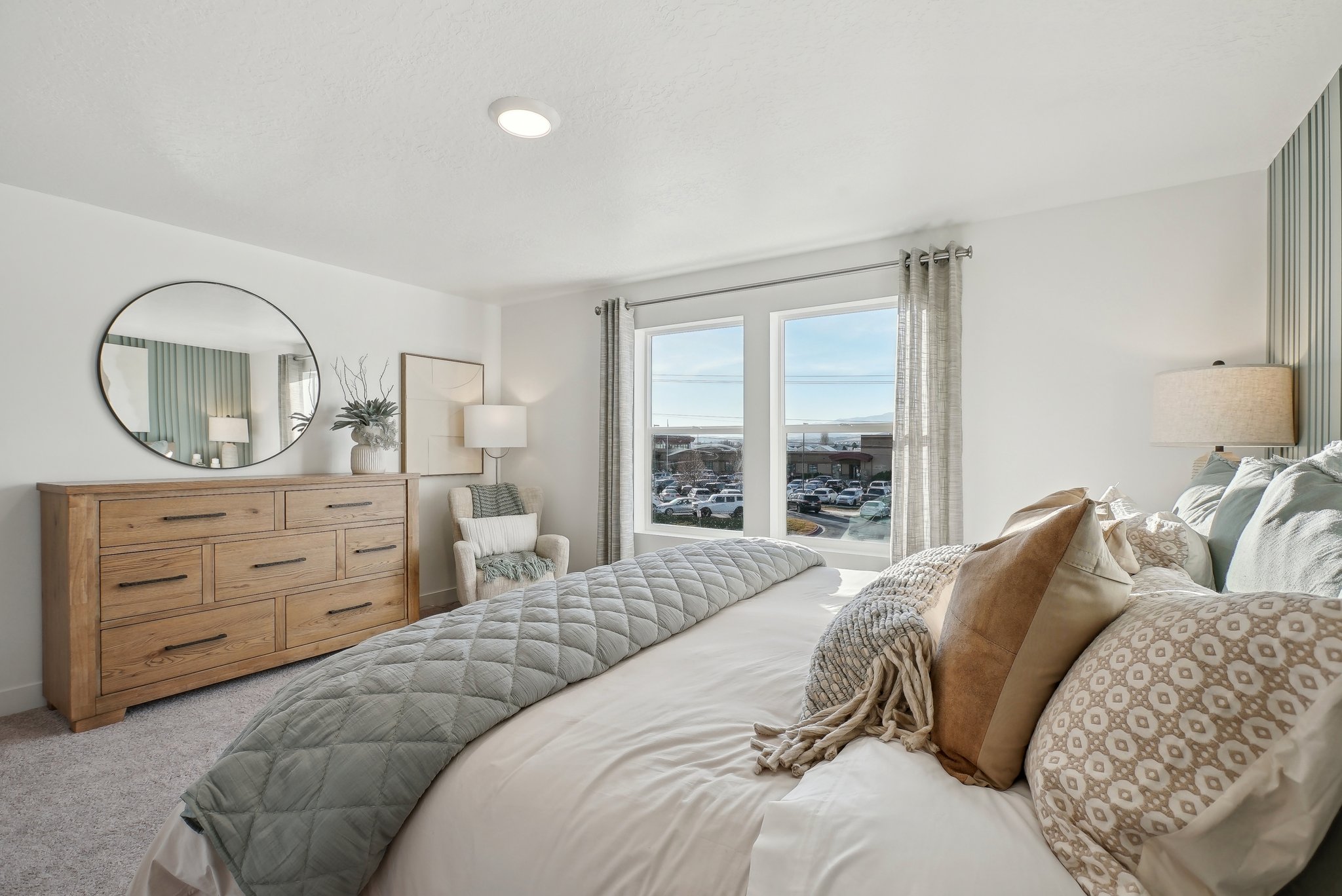 A bedroom with a large window.